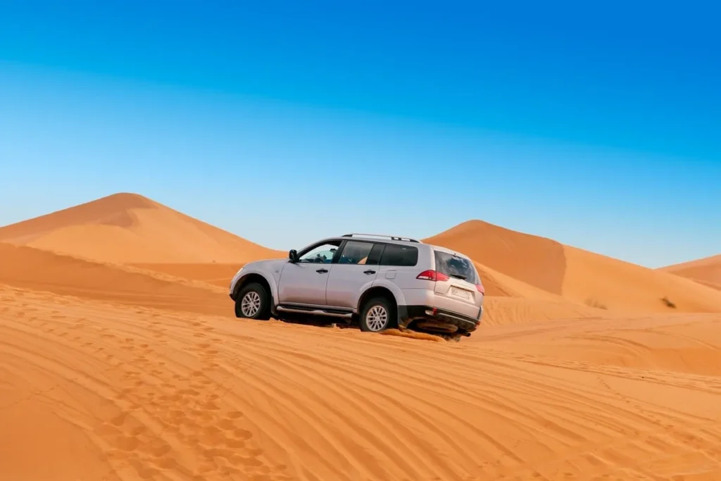4x4 vehicle approaching the massive dunes of Erg Chigaga.