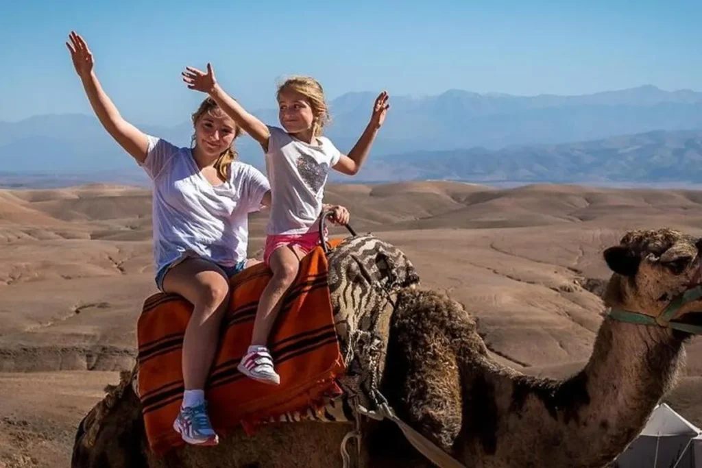 Camel ride experience in Agafay desert Morocco during a colorful sunset.