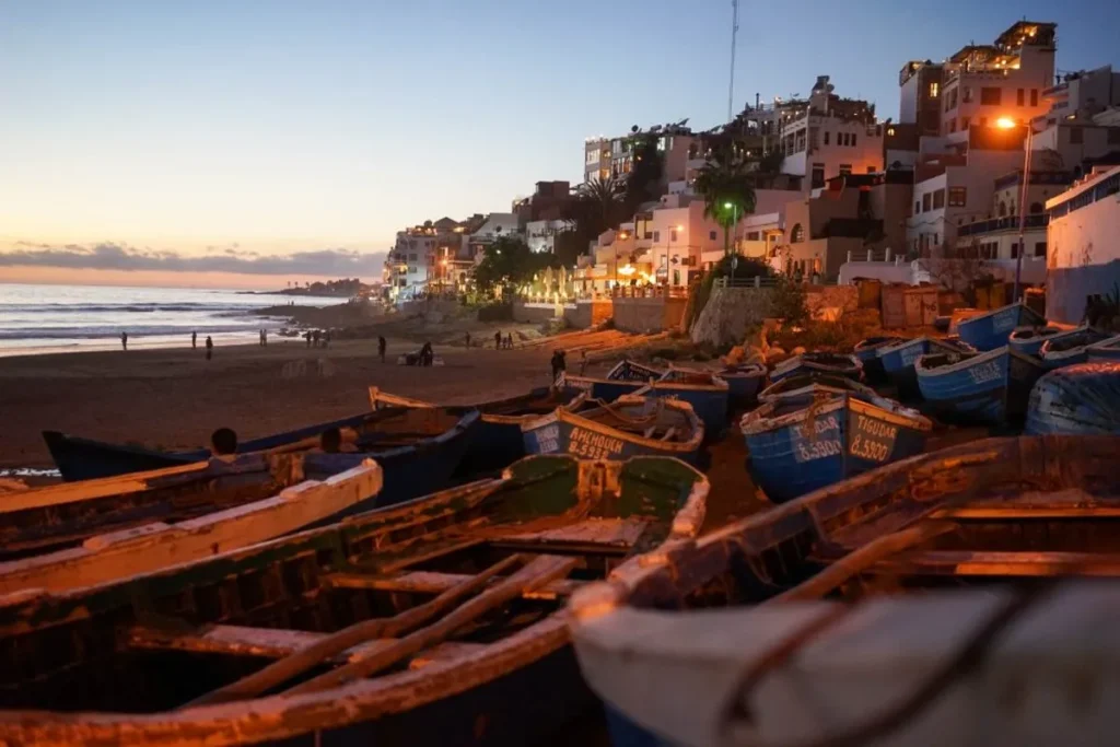 Quiet Tamraght Morocco beach contrasted with busy Taghazout streets.