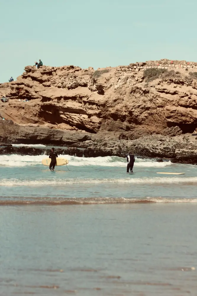 Surfer catching a wave at Tamraght beach near Devil's Rock.